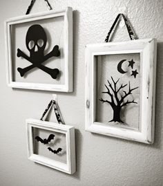 three framed halloween pictures hang on the wall