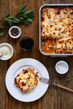 a casserole dish on a plate next to other dishes and condiments