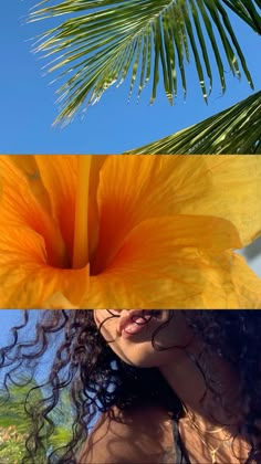 a woman with long curly hair standing next to a palm tree