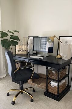 a black desk with a computer on it and some baskets in front of the desk