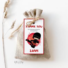 a small bag with a thank you tag attached to it