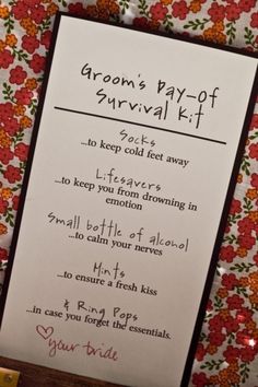 a card that is on top of a table with flowers and the words groom's pay - off survival kit