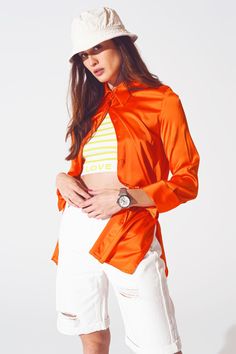 Add a touch of sophistication to your wardrobe with this Satin Shirt with Split Cuff in Orange. Made from a luxurious blend of 55% rayon, 43% viscose, and 3% spandex, this full-length shirt offers a relaxed and oversized fit, perfect for any classic occasion. The wide collar neckline and long sleeves create an elegant silhouette, while the satin fabric ensures a polished look. Designed to run true to size, our model, with measurements 33-24-35 and height 5'8", is wearing a size S. This stylish s Orange Satin, Blouse Neck, Elegant Blouses, Classic Wardrobe, Satin Shirt, Party Fashion, Relaxed Style, Belted Dress, Alternative Fashion