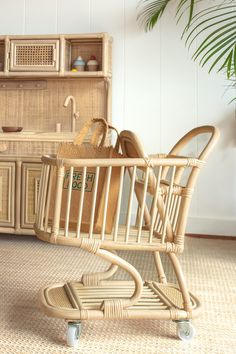 an empty shopping cart sitting in front of a wooden hutch with baskets on it