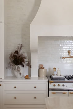 a white stove top oven sitting inside of a kitchen next to a wall mounted oven