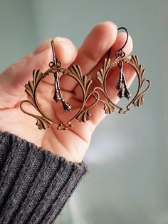 Drying Bundles- Herbal brass seed pod earrings with detailed Art Nouveau brass frames Coppery colored little plant seeds dangle inside a vintage art nouveau brass oval frame. The vintage(from the 1930s) leafy frames are so gorgeous! They are very detailed with little dots and elegant swirls and have a great reddish patina. The copper toned bronze sprigs look like they are all bundled and ready to dry. These lightweight earrings will hang 2 inches from your piercing on your choice of oxidized ste Art Nouveau Brass Jewelry Nickel Free, Art Nouveau Nickel-free Brass Jewelry, Antique Copper Earrings In Antique Gold, Antique Bronze Brass Earrings, Vintage Antique Gold Copper Earrings, Bronze Art Nouveau Jewelry With Antique Finish, Vintage Copper Pierced Jewelry, Vintage Metal Earrings, Handmade Art Nouveau Brass Jewelry