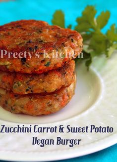 three patties on a plate with parsley in the background and text overlay that reads, zucchini carrot & sweet potato vegan burger