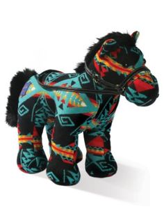 a small toy horse that is made out of fabric and has colorful patterns on it