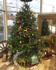 a decorated christmas tree sitting in front of a window