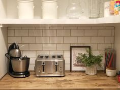 a kitchen counter with a toaster, coffee maker and other items on top of it