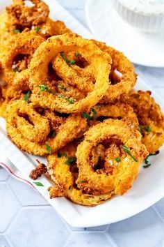 fried onion rings on a white plate