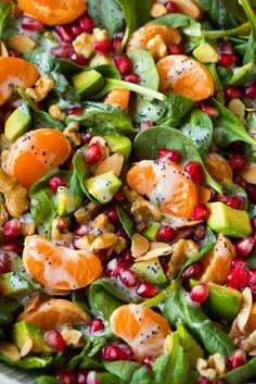 a salad with oranges, spinach and nuts