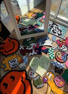 an assortment of rugs are on the floor in front of a mirror and door