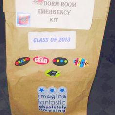 a brown bag with some stickers on it and a sign that says dorm room emergency kit