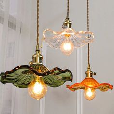 three light fixtures hanging from a ceiling in a room