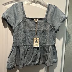 This Shirt Has A Lot Of Cute Details! Casual Medium Wash Short Sleeve Blouse, Fitted Light Wash Short Sleeve Tops, Light Wash Fitted Cotton Top, Fitted Light Wash Cotton Top, Casual Washed Tops For Summer, Casual Medium Wash Crew Neck Top, Washed Blue Relaxed Fit Top For Summer, Light Wash Cotton Tops For A Day Out, Trendy Washed Blue Tops For Day Out