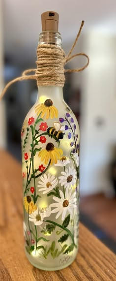 Whimsical bumble bees hand painted with wild flowers   LED fairy light bottle   Can be personalized with name   Or message me with a custom request ❤️ Bottle Fairy Lights, Bumble Bee Art, Wildflower Art, Hand Painted Wine Bottles, Painted Bottles, Hand Painted Bottles