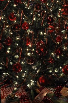 a decorated christmas tree with presents under it