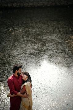 a man and woman standing next to each other in the water