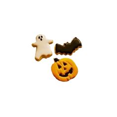 three halloween cookies on a white background with ghost and jack - o'- lantern