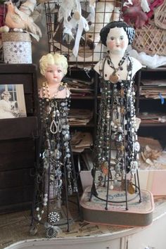 two mannequins are standing next to each other in front of some baskets