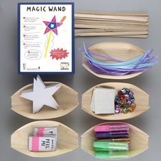 an assortment of crafting supplies displayed on wooden trays with magnets and paper