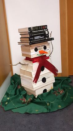 a stack of books with a snowman made out of them