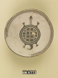 a white bowl with black designs on it