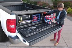 a man loading his truck with tools in the bed and tool box on the back