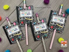 three candy lollipops are sitting on top of a table with confetti