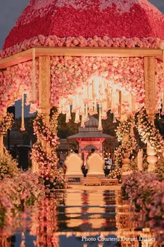 a gazebo decorated with flowers and candles