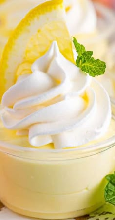 lemon pudding with whipped cream and fresh mint on the side, ready to be eaten