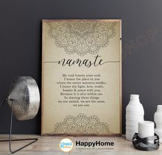 a poster with the words namaste on it next to candles and vases