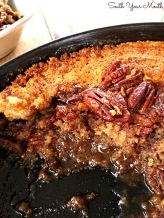 pecan pie in a cast iron skillet on a table with other food items