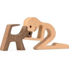 a wooden toy that is shaped like a dog and has its head on the other side of it