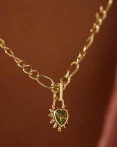 The sparkling peridot-green jewelled heart charm is a sweet addition to the chunky figaro chain necklace. When you wear this dazzling charm, we're sure you'll have your friends green with envy. 14k Gold-plated or Silver-plated brass Figaro chain Lobster clasp Packaged in our signature fabric gift pouch The charm measures 7 x 11 mm The figaro chain is 4 mm in thickness. The chain length measures 45 cm plus a 5 cm extender chain. Gold Necklace With Chunky Chain, Gold Chunky Heart Necklace, Chunky Charm Necklace, Chunky Pendant, Figaro Necklace, Figaro Chain Necklace, Pretty Accessories, Peridot Green, Dream Gift