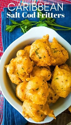 a white bowl filled with fried food on top of a table