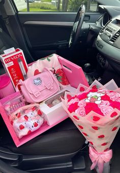 the interior of a car is decorated with pink roses and hello kitty items, including a purse