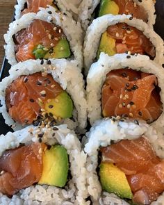 sushi rolls with salmon, avocado and sesame seeds