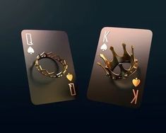 two playing cards with gold crowns and hearts on them, one in the shape of a king and queen