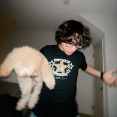 a young man holding a stuffed animal in his arms