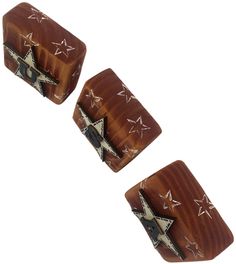 two wooden cufflinks with star designs on them