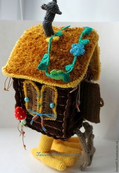 a crocheted birdhouse with a seahorse on it's roof and legs