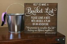 a bucket sits next to a sign that says, help us make a bucket list please leave a note with an idea a plan or an adventure