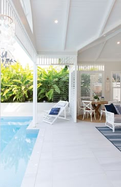 an outdoor living area with pool and patio furniture