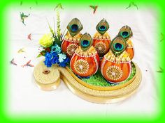 peacock figurines sitting on top of a decorative tray