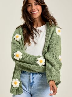 The thick-knit material is so soft, and the adorable daisies throughout are a perfect touch. Layer this with your favorite bodysuit and jeans for an effortless look. Style Taylor Swift Cardigan, Chic Cozy Fit Sweater For Spring, Spring Cable Knit Loungewear Cardigan, Spring Cable Knit Cardigan For Loungewear, Comfortable Cozy Sweater For Spring, Cozy Fit Sweater For Spring, Spring Cable Knit Sweater, Spring Cable Knit Outerwear For Loungewear, Trendy Chunky Knit Cardigan For Loungewear