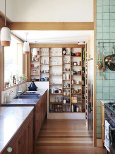 a kitchen with lots of wooden cabinets and shelves