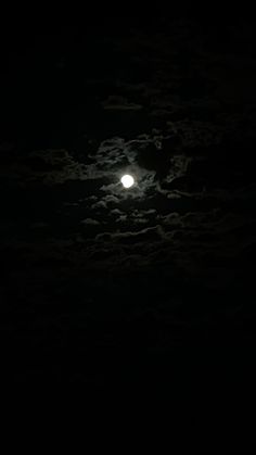 the moon is shining brightly in the dark sky