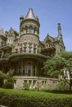 an old victorian style house with turrets on the top floor and balconies